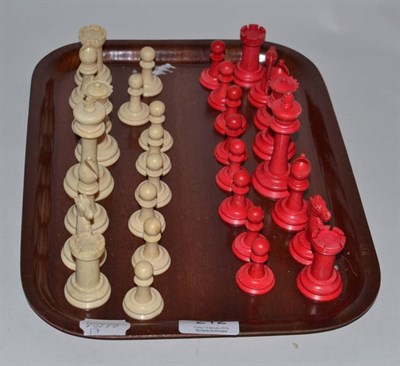 Lot 212 - A red stained and natural bone chess set