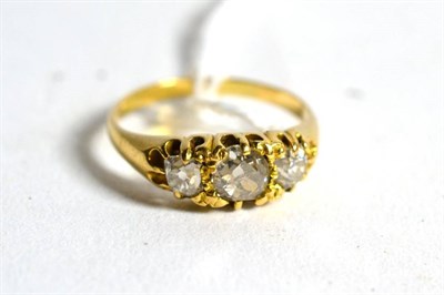 Lot 227 - An old cut diamond three stone ring, graduated diamonds in a carved setting, total estimated...