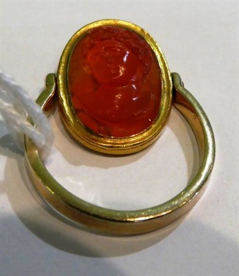 Lot 228 - A carved carnelian cameo mounted swivel ring, carved in high relief depicting the bust of...