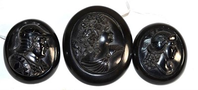 Lot 231 - Three jet cameo brooches, two carved depicting Roman soldiers, measuring 5.6cm by 4.6cm and another