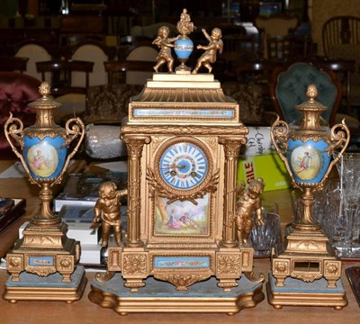 Lot 251 - A French clock garniture, late 19th century eight day movement, porcelain panels, cherub decoration