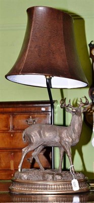 Lot 265 - A bronzed metal lamp modelled as a stag and a pair of brass and steel andirons