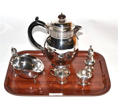 Lot 275 - A silver hot water jug, Finnigans Ltd, London 1917; a silver sauceboat; and a three piece condiment