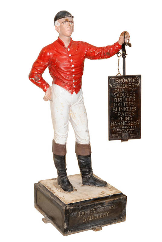 Lot 1327 - A Cast Iron Figure of a Jockey, standing full length, wearing cap, red jacket, white breeches...
