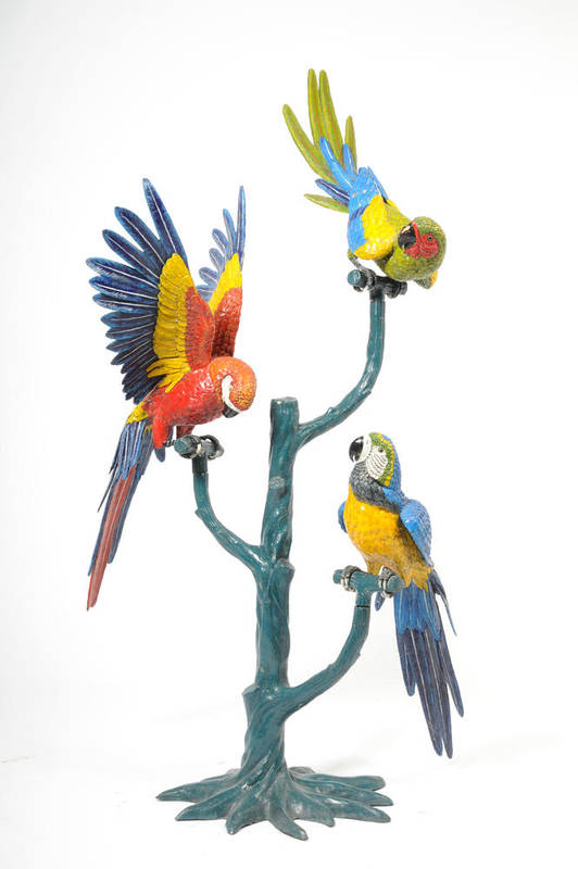 Lot 1348 - A Cold Painted Bronze Group of Three Macaws, 20th century, each perched on an individual...