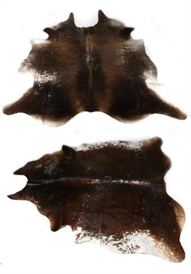 Lot 63 - Taxidermy: Two Cowhide Floor Rugs, modern, two large modern brown and white natural cowhide...