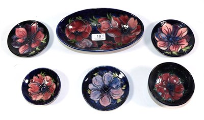 Lot 19 - A group of Moorcroft Anemone pattern pottery, comprising: three coasters; two circular dishes;...