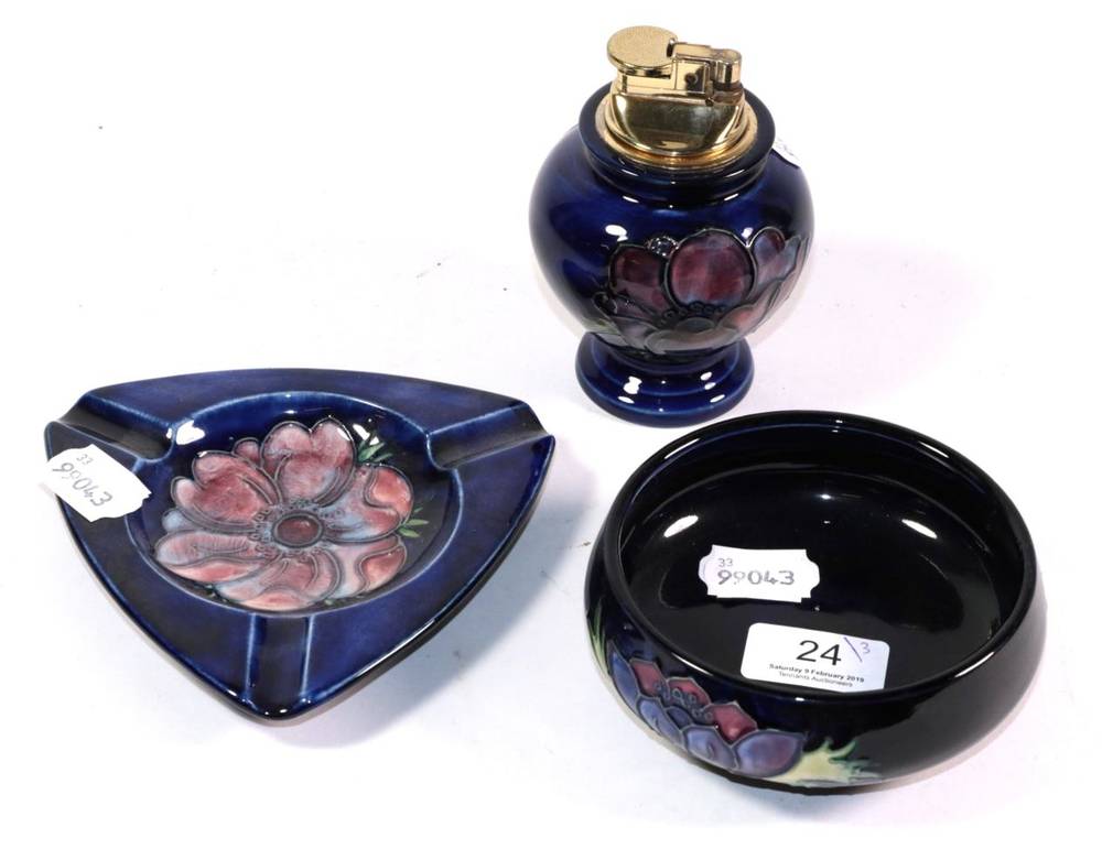 Lot 24 - A Moorcroft pottery Anemone pattern table lighter, ashtray and bowl, each with impressed marks, the