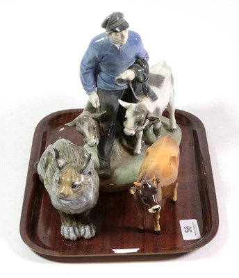 Lot 56 - A Royal Copenhagen ceramic figure of a boy and calves; another of a lynx and a Beswick cow (a.f.)