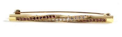 Lot 90 - An 18 carat gold diamond and ruby bar brooch, length 5.5cm
