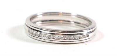 Lot 92 - An 18 carat white gold diamond half hoop ring, a central channel set diamond band between two plain