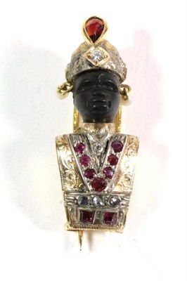 Lot 96 - A twentieth century gem set Blackamoor brooch, modelled with a carved ebony face and wearing a...