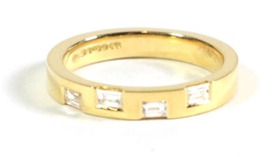 Lot 108 - An 18 carat gold diamond band ring, inset with four baguette cut diamonds, total estimated...