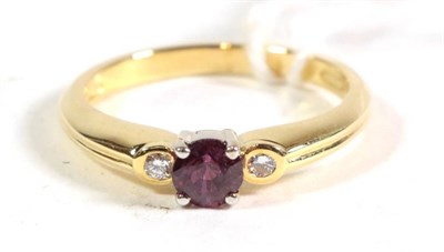 Lot 113 - An 18 carat gold ruby and diamond three stone ring, finger size N1/2