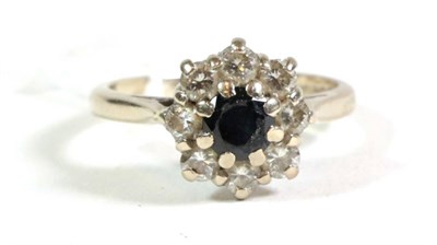 Lot 115 - An 18 carat gold sapphire and diamond cluster ring, finger size M
