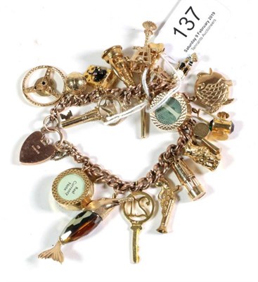 Lot 137 - A 9 carat gold curb link charm bracelet, with seventeen 9 carat gold charms; two loose 9 carat gold
