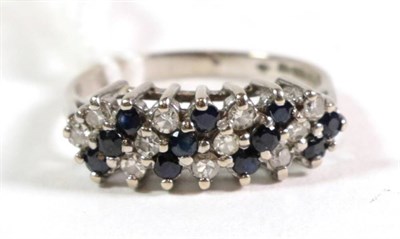 Lot 143 - An 18 carat white gold diamond and sapphire three row ring, total estimated diamond weight 0.25...