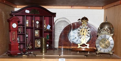 Lot 178 - A reproduction skeleton passing strike wall clock; a reproduction lantern form mantel...