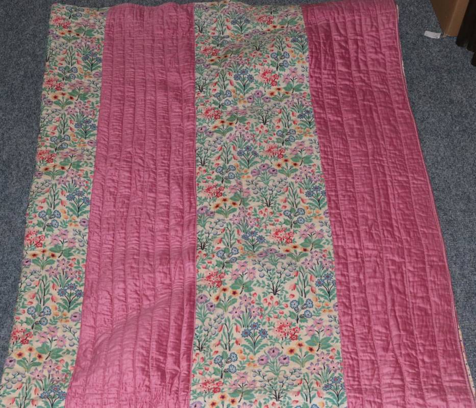 Lot 1022 - Circa 1930s pink striped and cotton floral strippy quilt with spotty printed cotton reverse,...