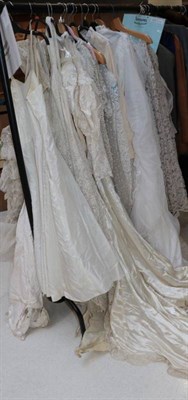 Lot 1072 - Seventeen circa 1940s and later wedding dresses, some lace or net mounted (some a.f.) (on a rail)