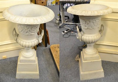 Lot 1196 - A pair of cast metal painted garden urns on stands