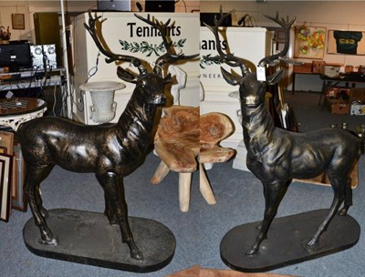 Lot 1200 - A pair of large patinated bronzed stags