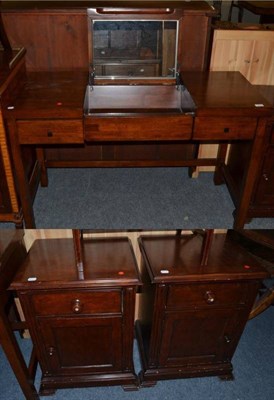 Lot 1215 - A John Lewis mahogany dressing table and a pair of mahogany bedside cupboards (3)