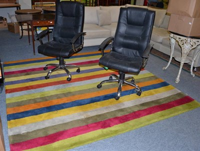 Lot 1241 - A pair of leather and chrome swivel office chairs and an Ikea striped carpet