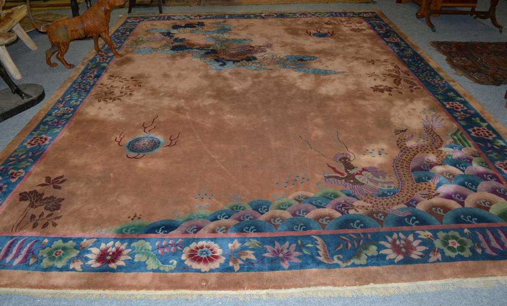 Lot 1242 - Chinese carpet, circa 1930, the camel field with dragon chasing a flaming pearl enclosed by...