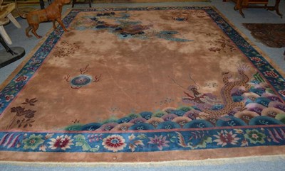 Lot 1242 - Chinese carpet, circa 1930, the camel field with dragon chasing a flaming pearl enclosed by...