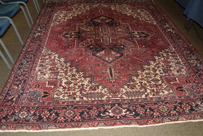 Lot 1246 - Heriz Carpet, Iranian Azerbaijan, the raspberry field with indigo medallion enclosed by samovar...