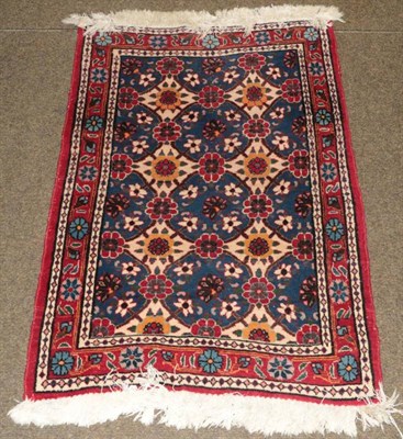 Lot 1252 - A small floral design red ground rug