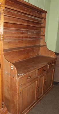 Lot 1273 - A Victorian pine dresser, the upper section with three plate racks, shaped ends, the base...