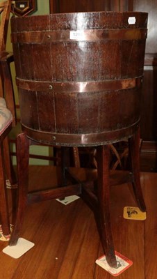 Lot 1284 - An oak barrel type wine cooler on stand