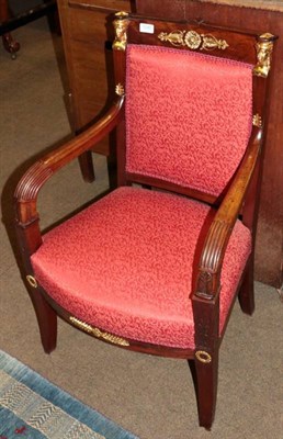 Lot 1285 - A mahogany and gilt metal mounted armchair, late 19th century, in Empire style, recovered in...