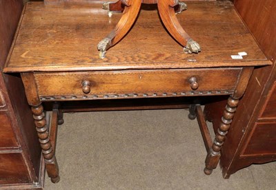 Lot 1293 - A carved oak side table fitted with a frieze drawer