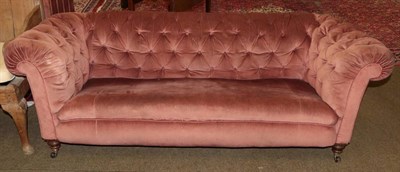 Lot 1312 - A Victorian Chesterfield sofa recovered in pink buttoned velvet, 200cm wide