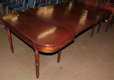 Lot 1315 - A mahogany D-end dining table, early 19th century, with reeded edge above a plain frieze, on turned