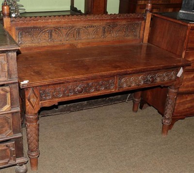 Lot 1317 - A Victorian carved oak serving table with superstructure back and two frieze drawers, 136cm wide