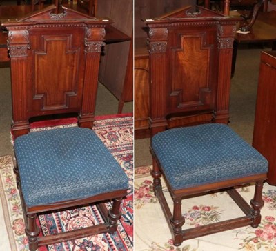 Lot 1332 - A pair of architectural form carved mahogany hall chairs