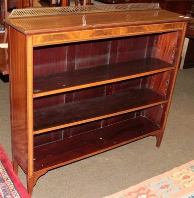 Lot 1335 - A 19th century crossbanded mahogany three tier open bookshelf with pierced brass gallery