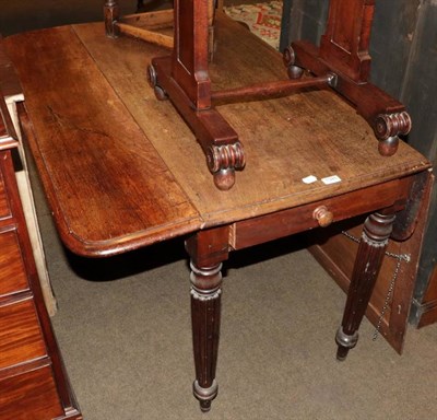 Lot 1345 - An early 19th century mahogany Pembroke table on reeded legs