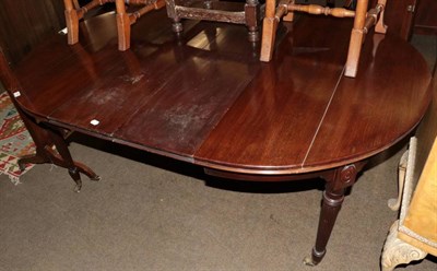 Lot 1355 - A 19th century mahogany wind out dining table, with two additional leaves, on reeded legs