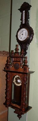 Lot 1358 - A Vienna type striking wall clock and a carved oak cased aneroid barometer (2)