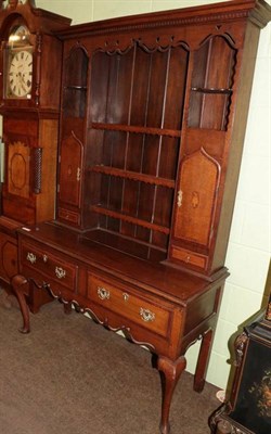 Lot 1368 - An oak and mahogany crossbanded dresser and rack, in George III style, the dentil cornice above...