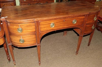 Lot 1375 - A George III mahogany breakfront sideboard, early 19th century, with central frieze drawer above an