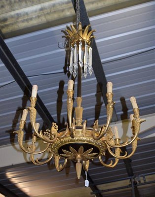 Lot 1377 - A French empire style gilt and patinated metal ten-light electrolier, with fluted column and scroll