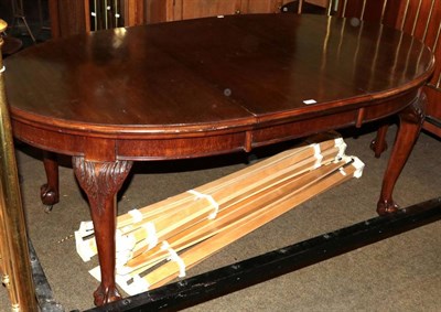 Lot 1379 - A mahogany wind-out dining table on ball and claw feet