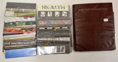 Lot 251 - GB Presentation Packs - a large quantity in an album and box 1970's to post 2000. Face value...