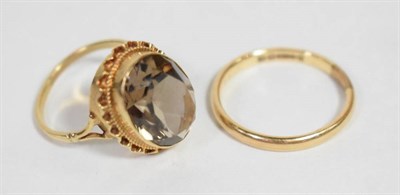 Lot 4 - A 9 carat gold band ring, finger size T; a Victorian smokey quartz ring in a yellow metal...